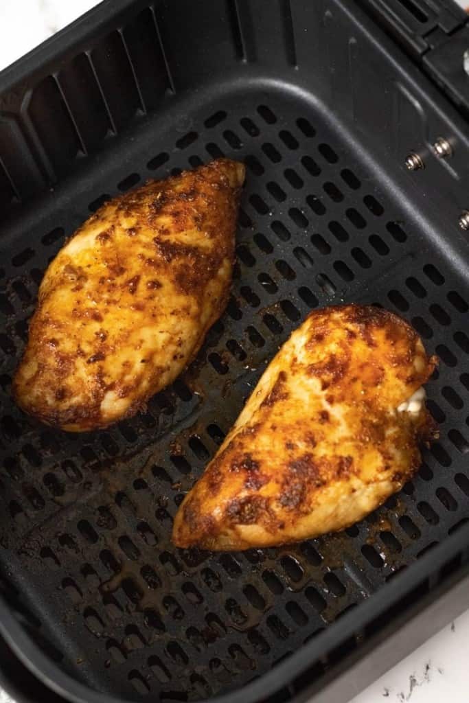 Cooked frozen chicken in air fryer overhead view