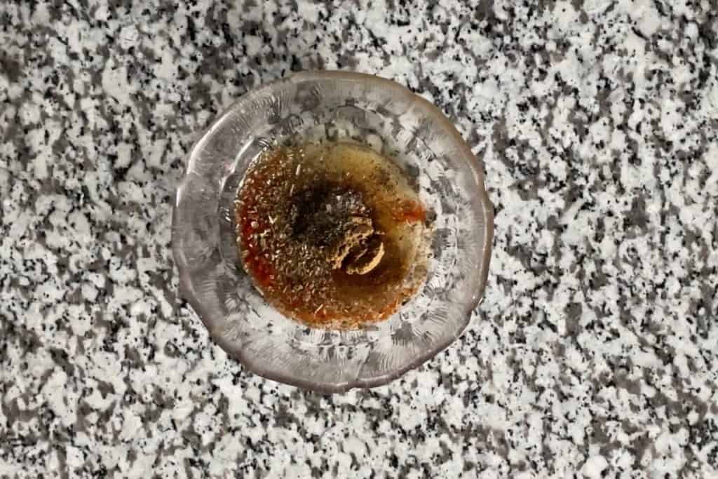 Spices and oil added into a clear bowl