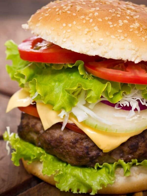 Hamburger that was cooked from frozen in the air fryer on a sesame bun with lettuce, tomato, onion, and cheese