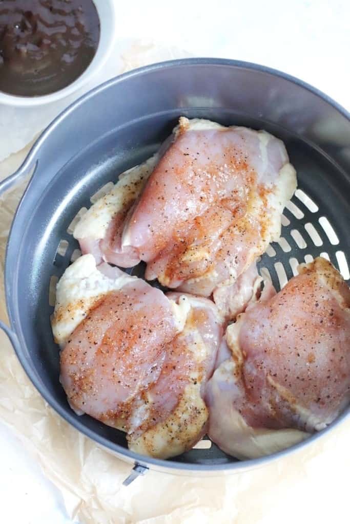 Raw chicken thighs in Ninja Foodi basket