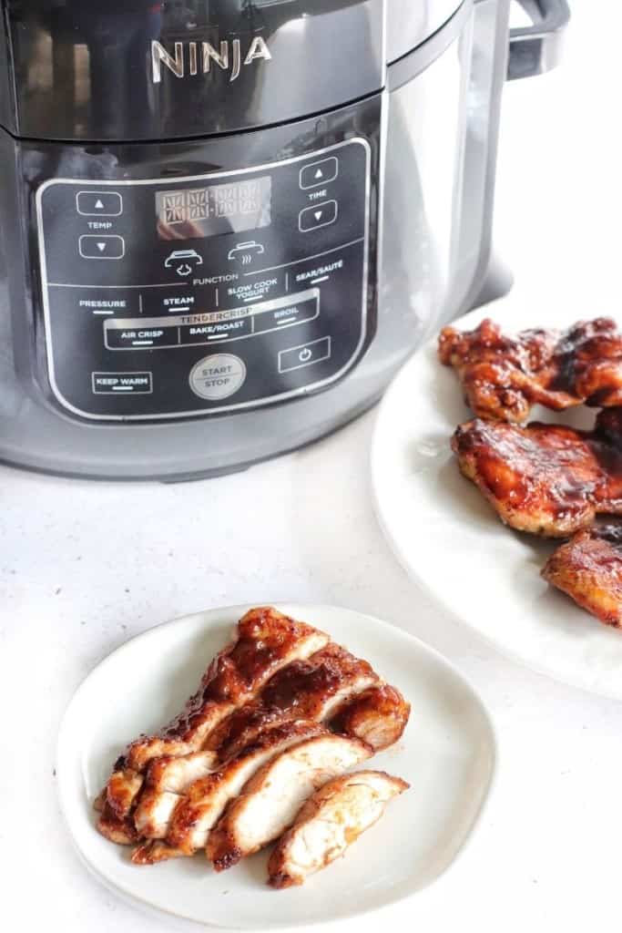Cut BBQ chicken thighs in front of the Ninja Foodi