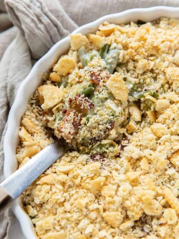 Green Bean Casserole in a round casserole dish with a serving spoon inside