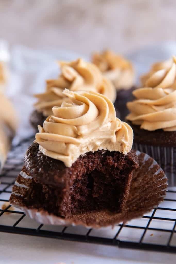 Cupcake with bite taken out topped with peanut butter frosting