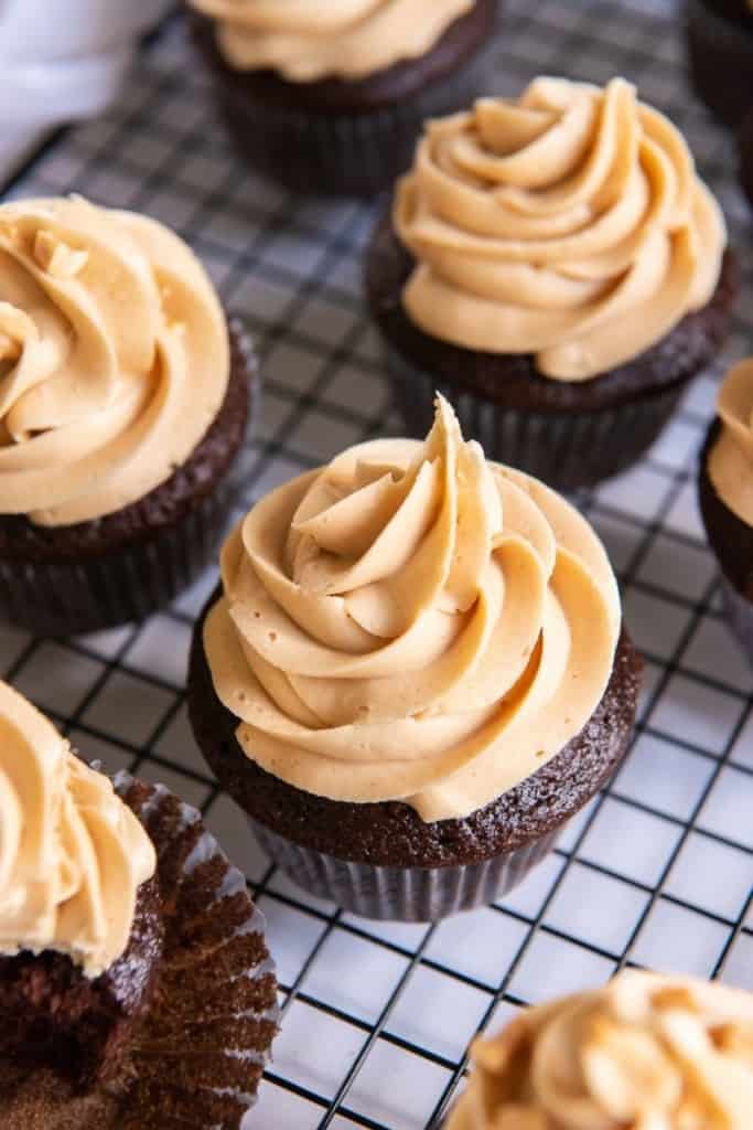 Chocolate cupcakes frosted and on a wire cooling rack