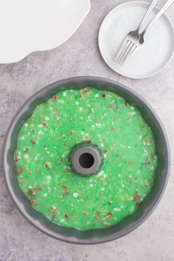 Green jello salad in a bundt pan that needs to be cooled and allowed to set.
