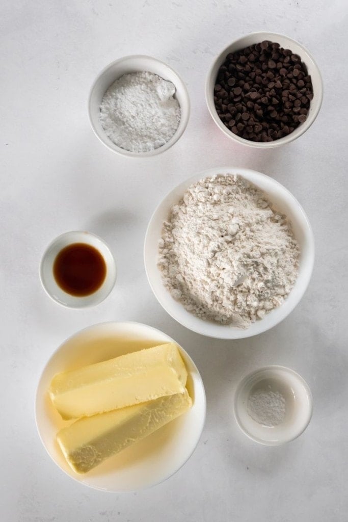 Ingredients needed to make snowball cookies in separate bowls