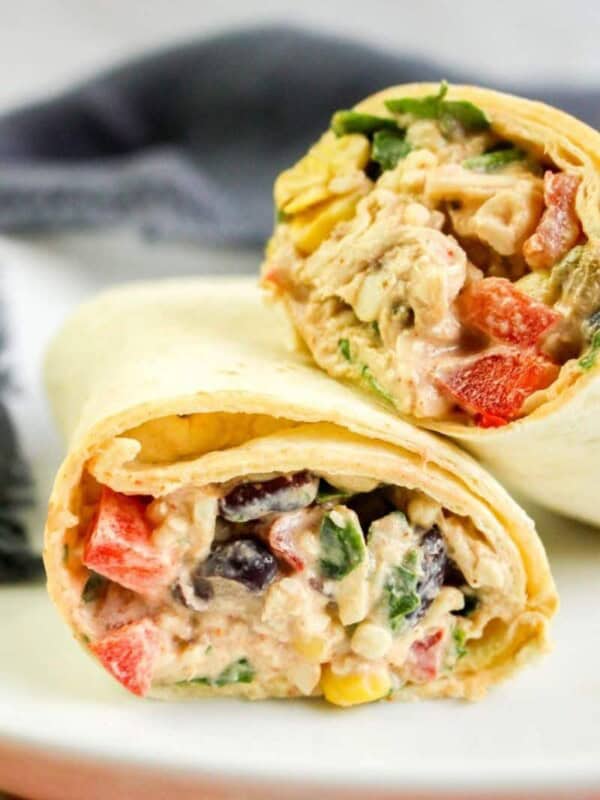 Southwest Chicken Wraps cut in half on a white plate and leaned on top of each other
