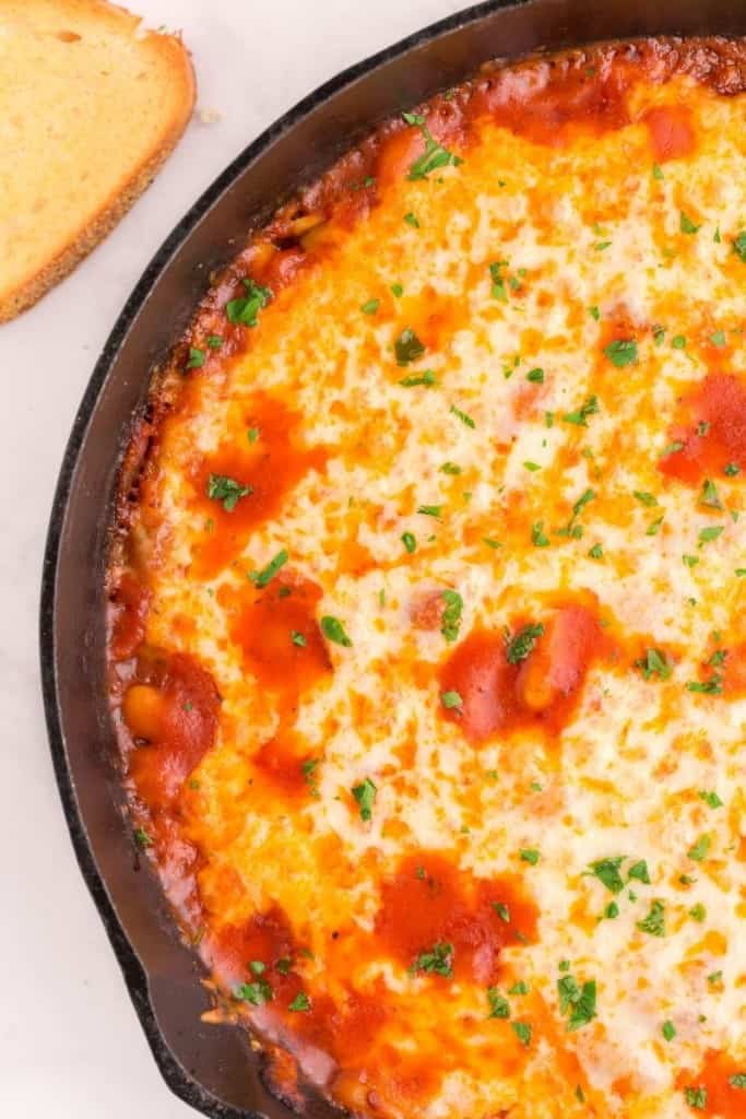 cheesy white bean tomato bake in a dish
