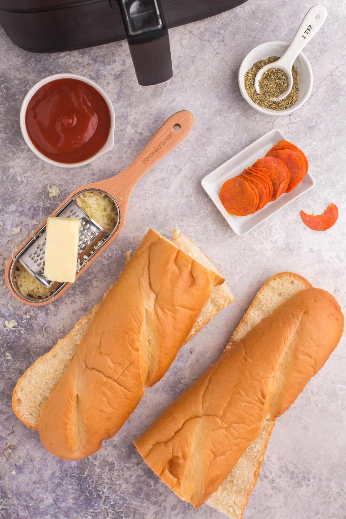 Ingredients needed to make french bread pizza in the air fryer: french bread loaf, marinara, mozzarella cheese, italian seasoning, and pepperoni.