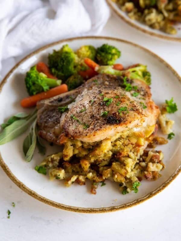 Air Fryer Stuffed Pork Chops on a plate with veggies on the side.
