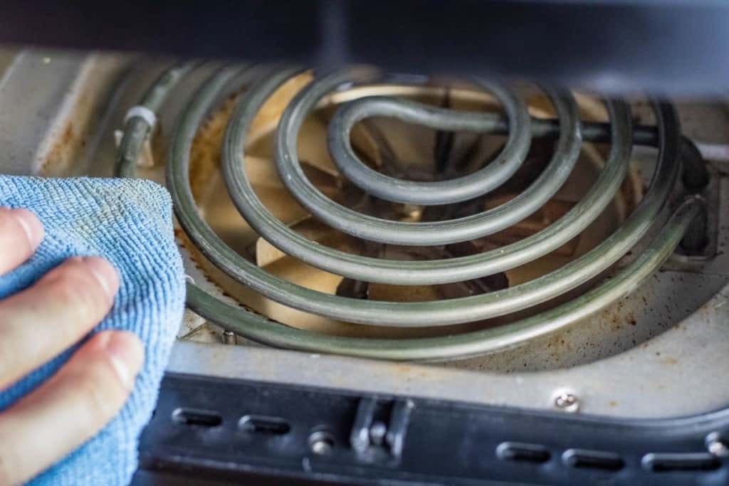 Air Fryer Coil being cleaned by a microfiber cloth