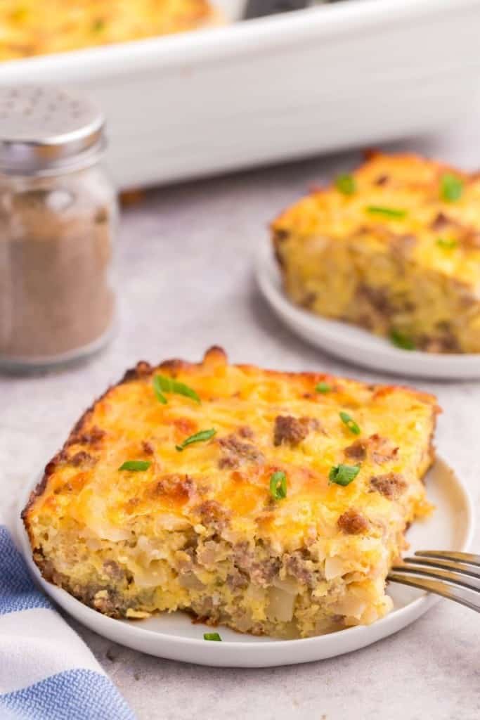 Piece of 5-ingredient hash brown casserole on plate with fork