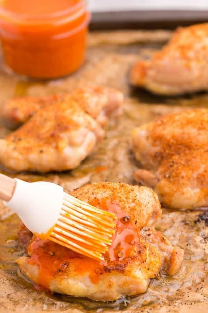 Buffalo chicken thighs with buffalo sauce baste