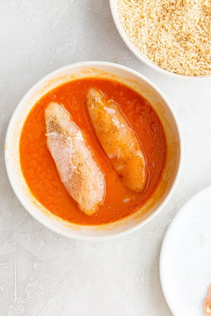 dip chicken tenders into egg and buffalo sauce mixture