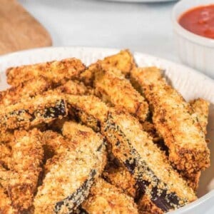 Full plate of breaded eggplant fries from air fryer