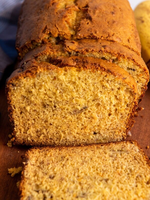 Close up of the banana bread that has been cut into so you can see the moist texture of the bread on the inside.
