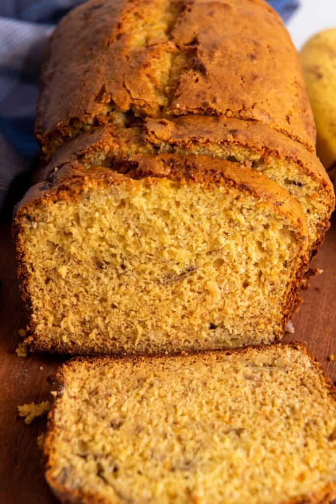 Close up of the banana bread that has been cut into so you can see the moist texture of the bread on the inside.