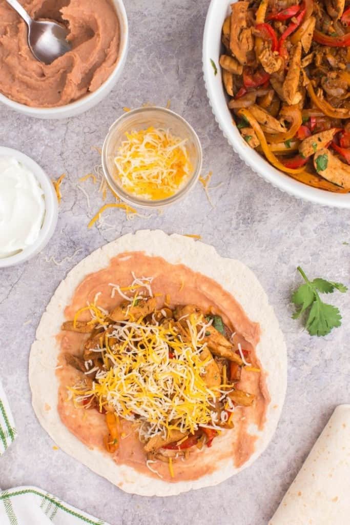 scoop beans and fajita mixture onto tortillas