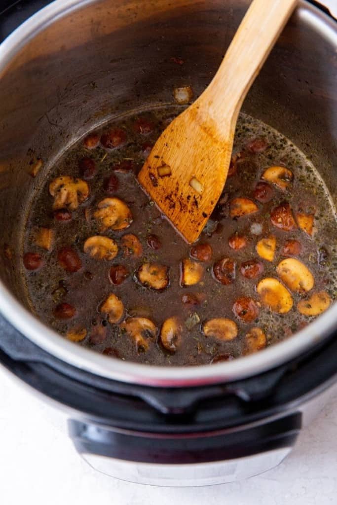 add the marinade to the onion and mushrooms in instant pot