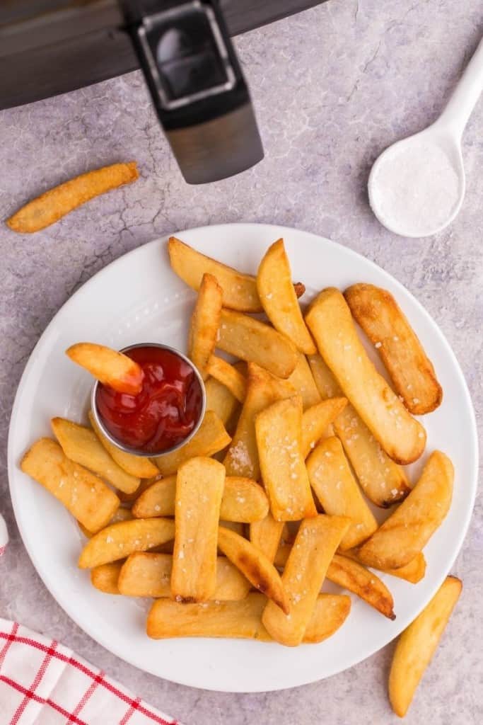white plate with air fryer steak fries and dipping sauce on side