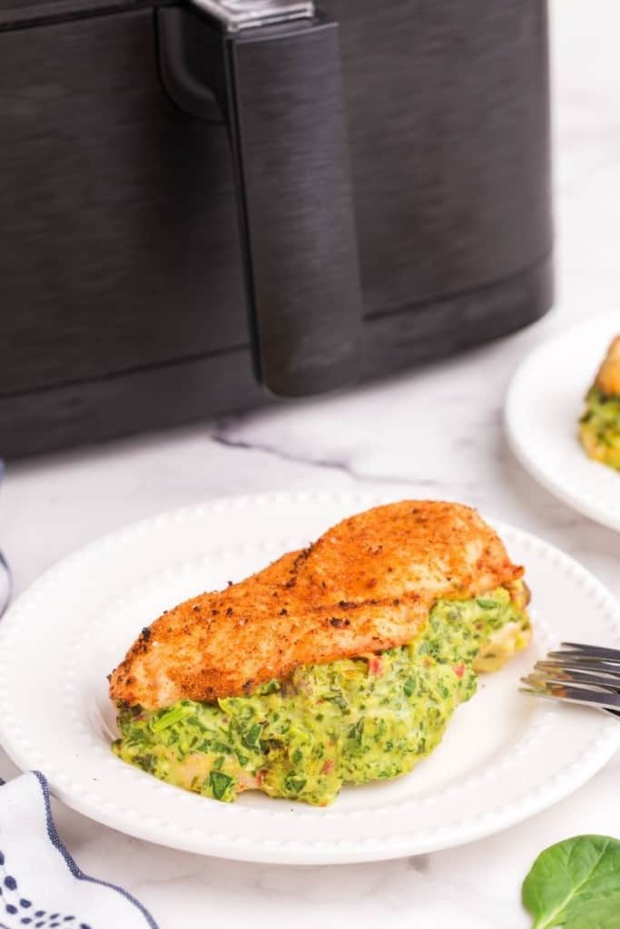 white plate with air fryer stuffed chicken breast