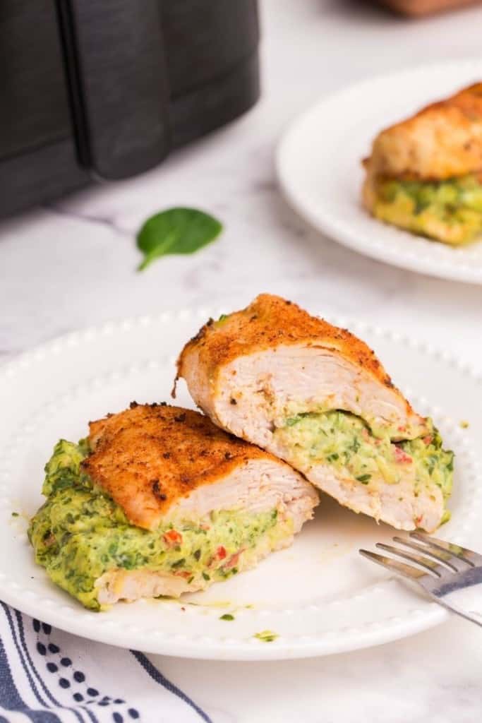 stuffed chicken breast cooked in air fryer on white plate