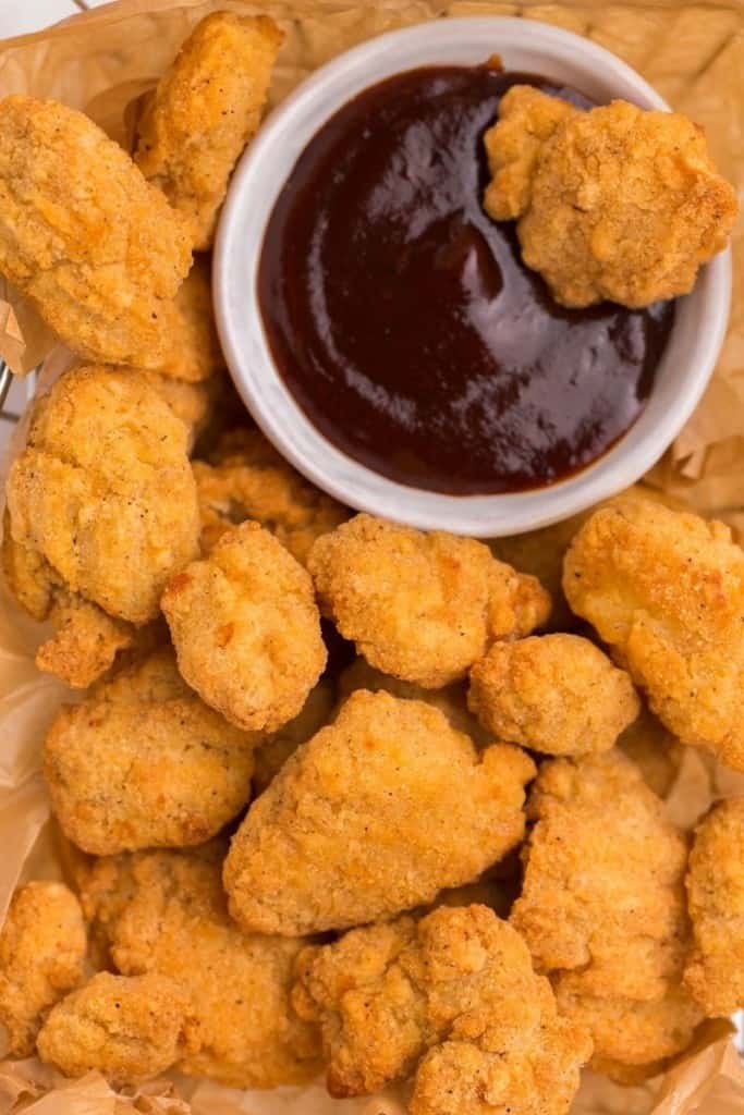 Crunchy popcorn chicken bites with bbq sauce on the side