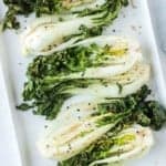 Seasoned air fryer bok choy on white plate