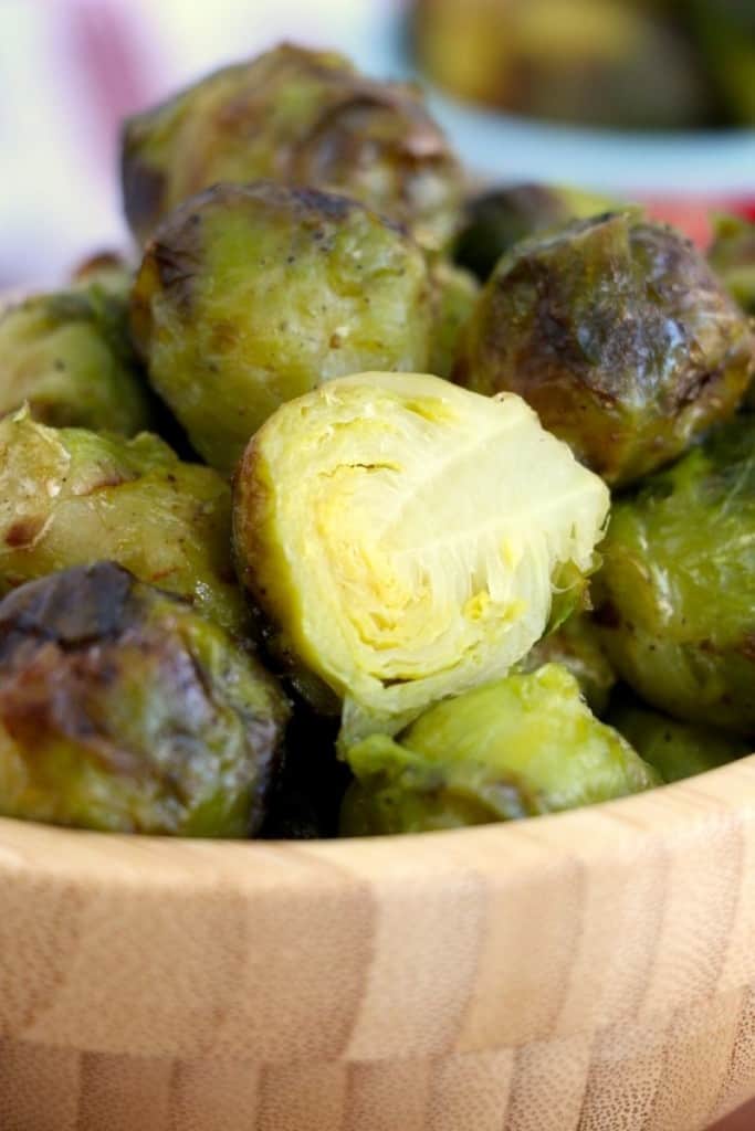 brussel sprout cut in half in bowl with other sprouts