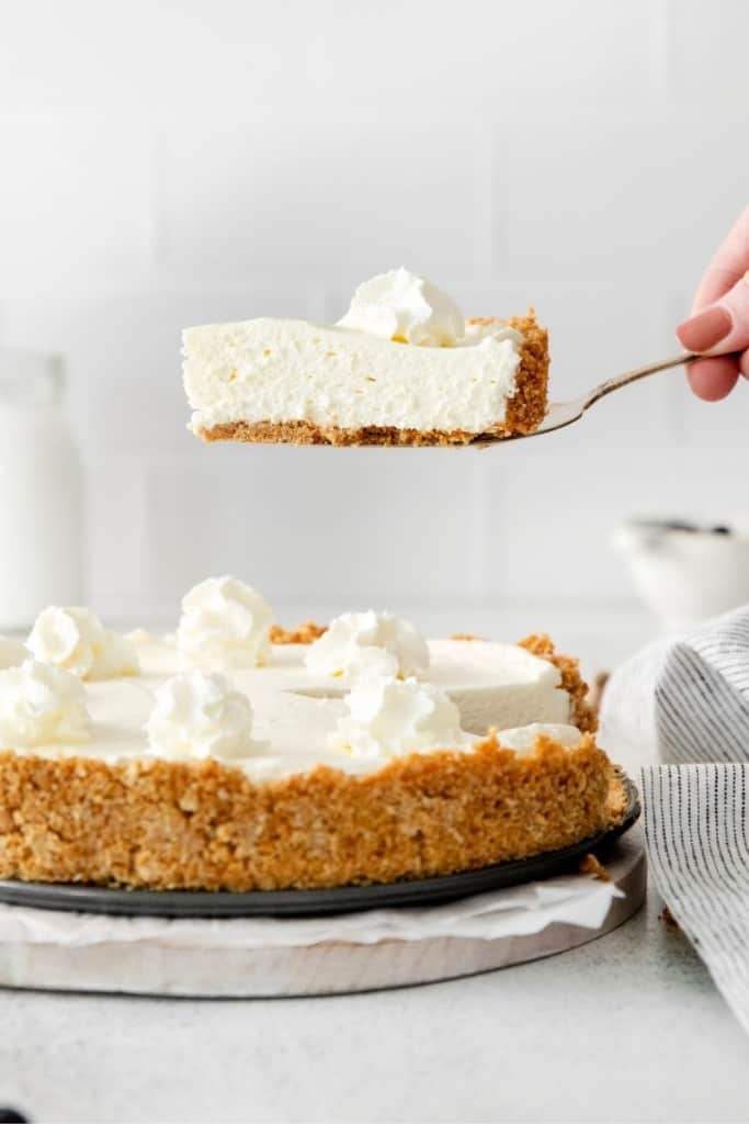 pie spatula removing slice of no-bake cheesecake