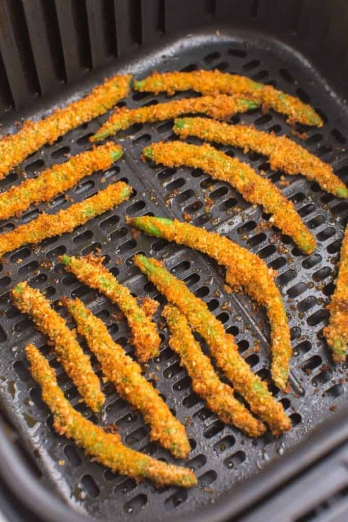 close up of green bean fries in air fryer