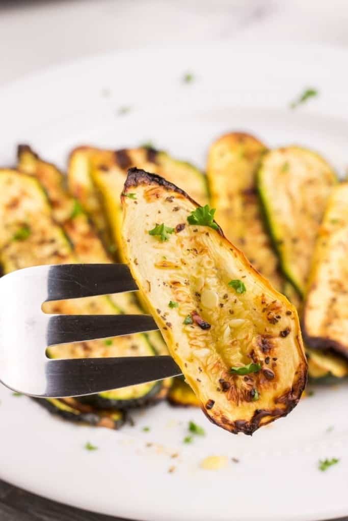 fork picking up slices of air fryer squash