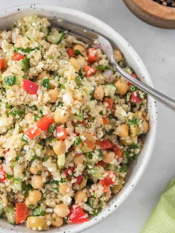 close of white salad bowl full of quinoa salad