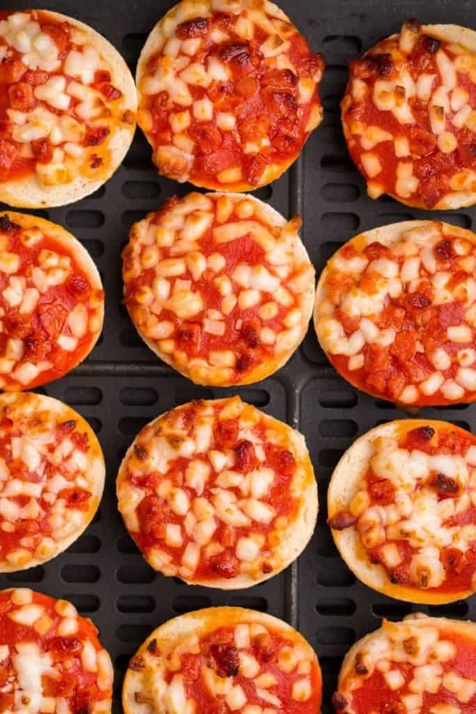 close up of bagel bites cooking in air fryer