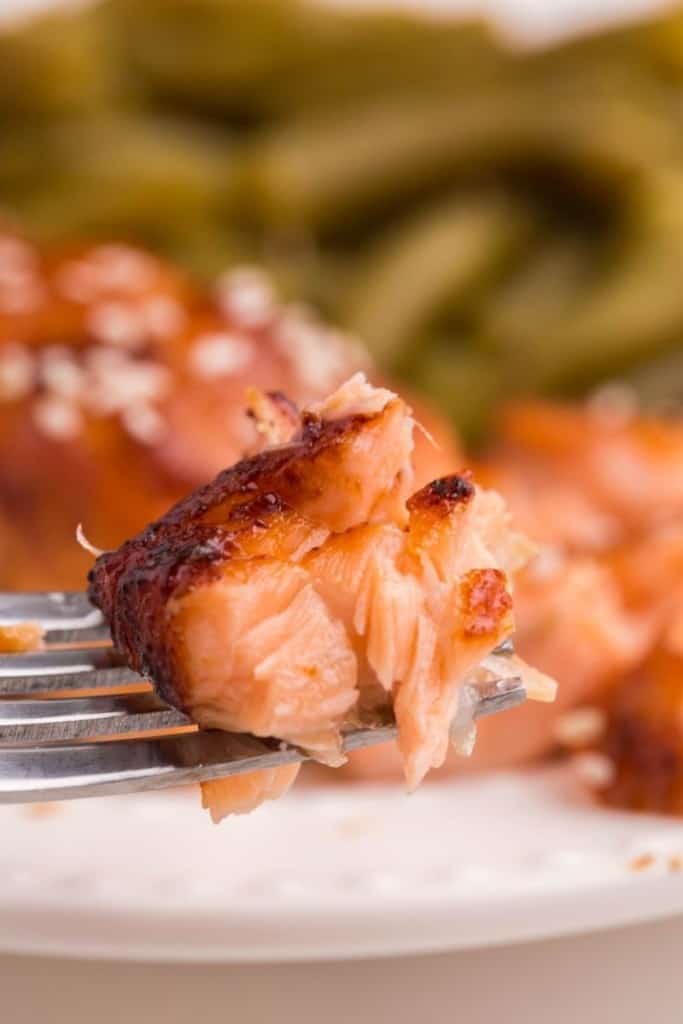 Piece of soft and juicy air fryer teriyaki salmon on fork