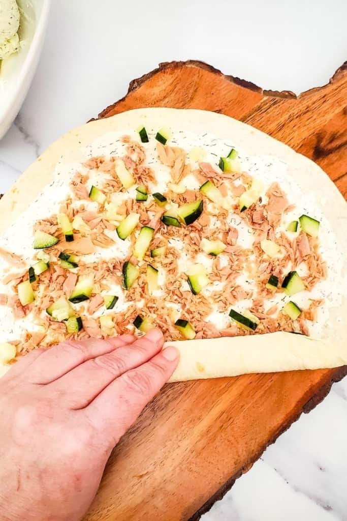 spread ingredients on tortilla and begin to roll it up