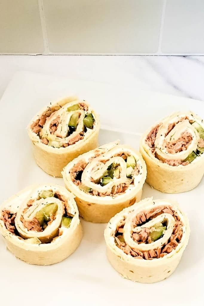 five tuna pinwheels arranged on plate