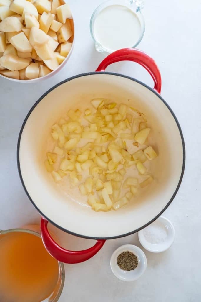 pour chicken broth to cover potato slices