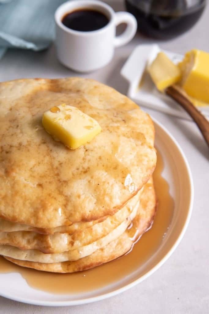 stack of air fryer pancakes with syrup drizzled on top