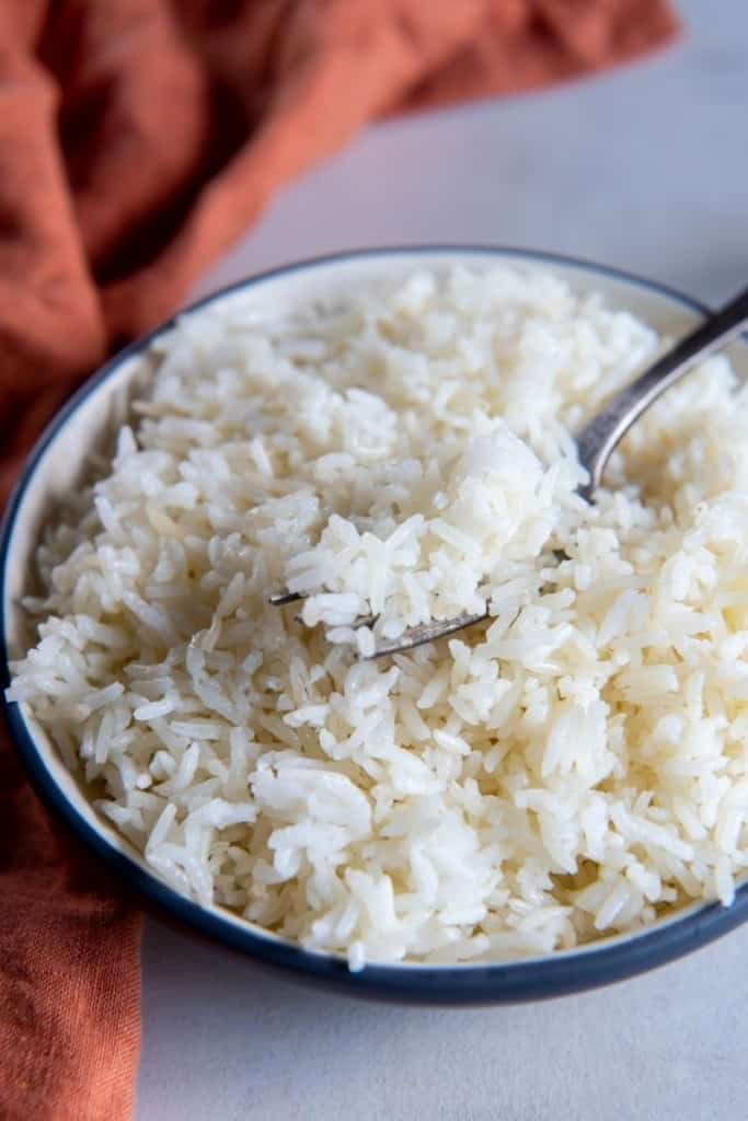 Air fryer rice in white bowl with fork