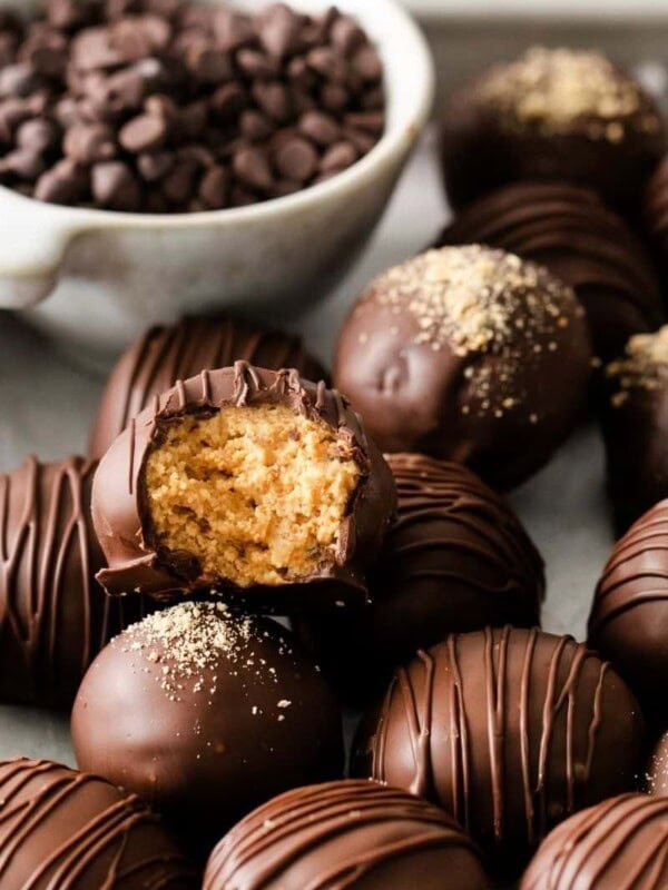 Pile of peanut butter balls and the top one has a bite taken out of it