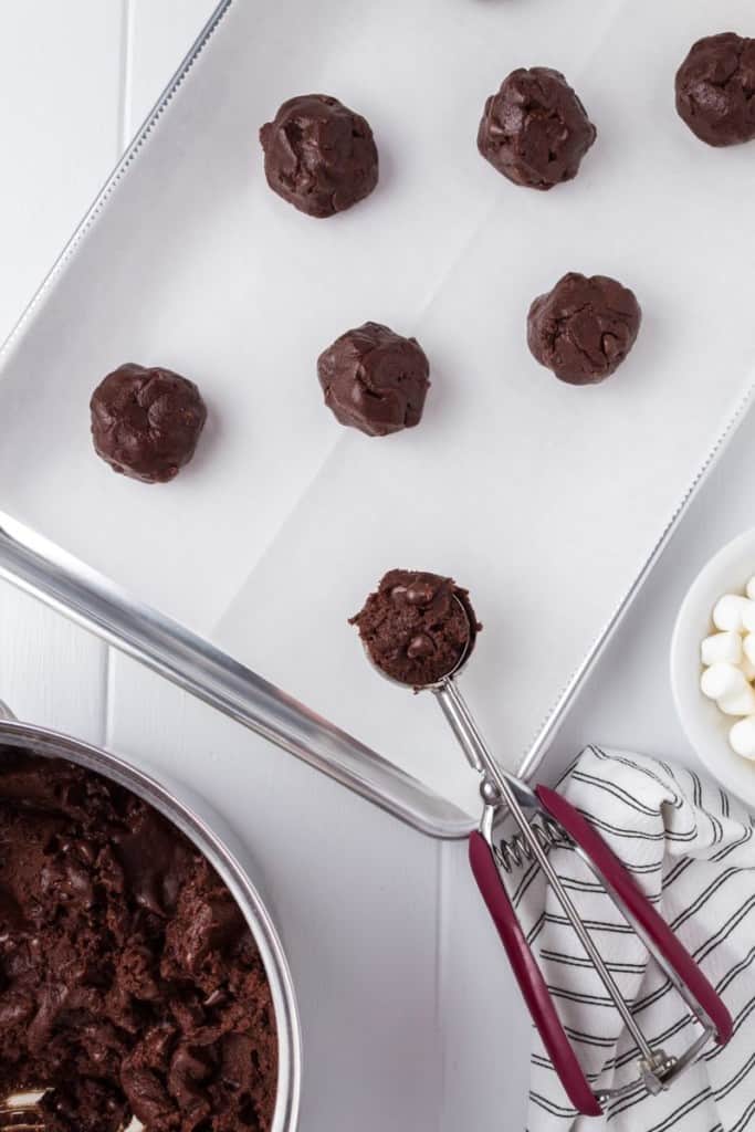 chocolate cookie dough scooped onto baking sheet