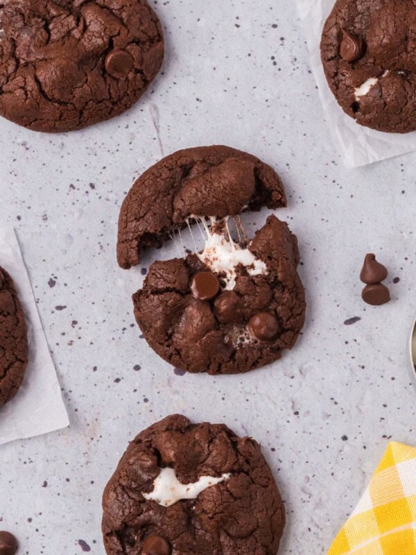 chocolate cookie with marshmallows being pulled apart