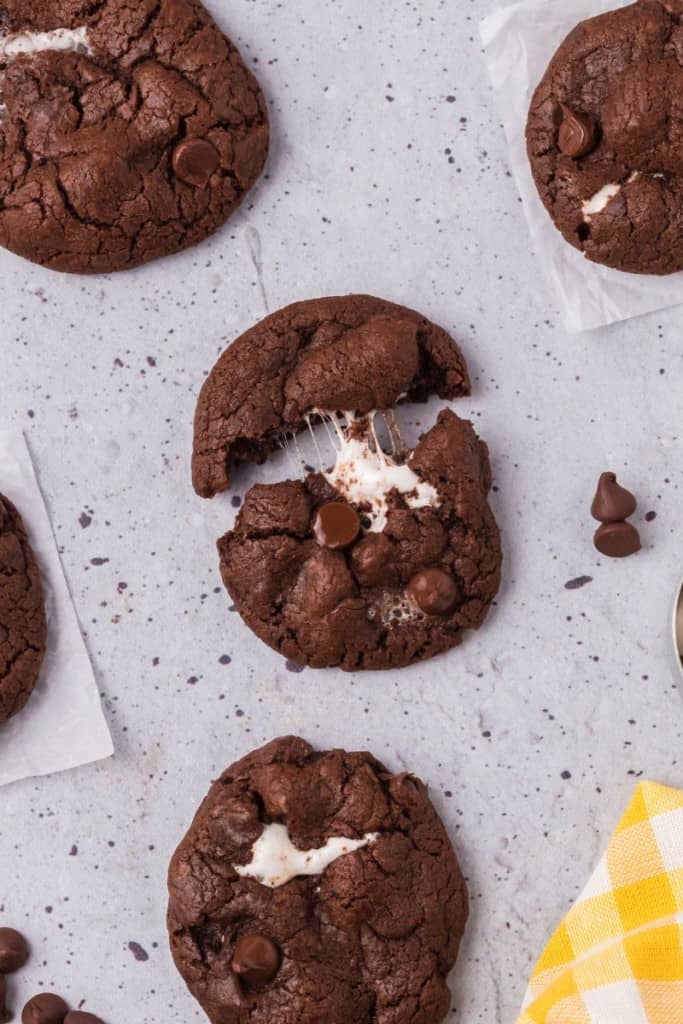 chocolate cookie with marshmallows being pulled apart