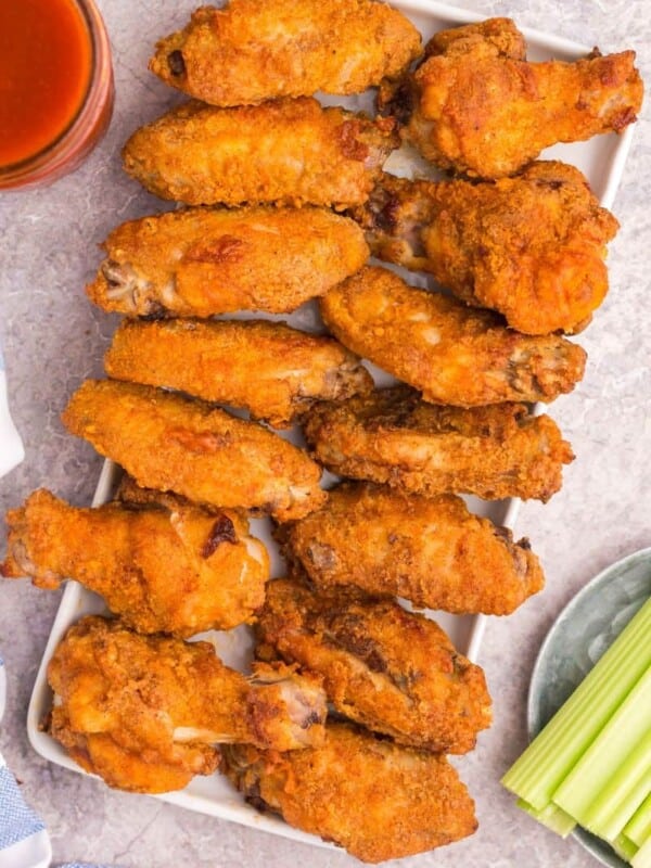 platter overflowing with cooked chicken wings