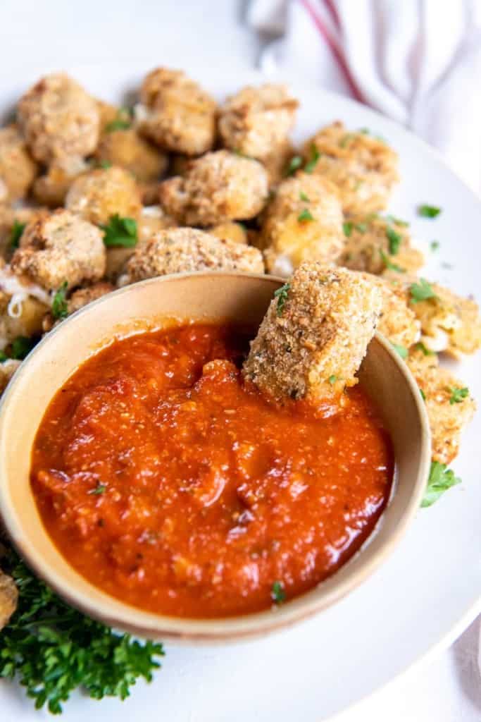 dipping cheese curd into sauce