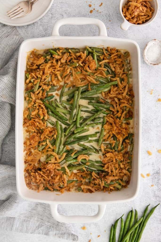 baked green bean casserole without cream of mushroom soup in a white baking dish.