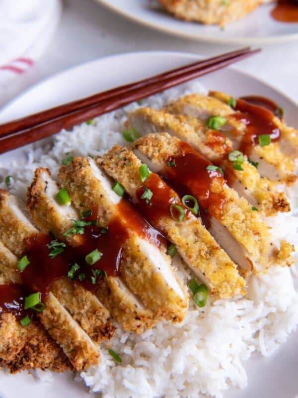 Air fryer chicken katsu being served over rice with sauce on top.