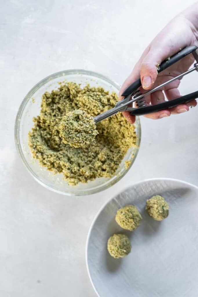 using a scoop to make falafel balls