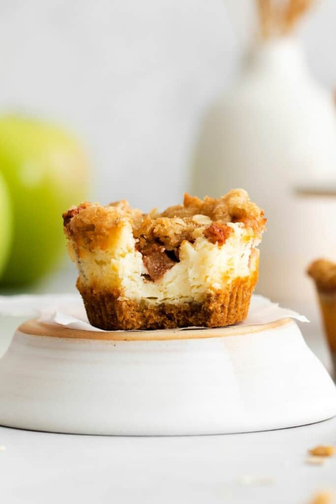 apple crisp cheesecake with bite out of it